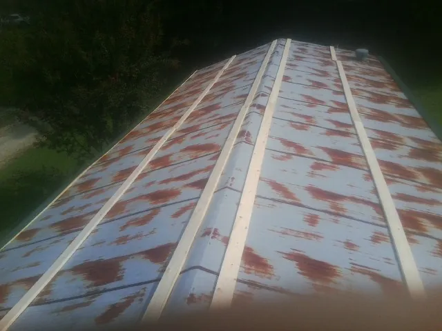 Rusted metal roof panels with new wood purlins before replacement — Storm Damage Roof Repair in Bowen by Roofing Brothers
